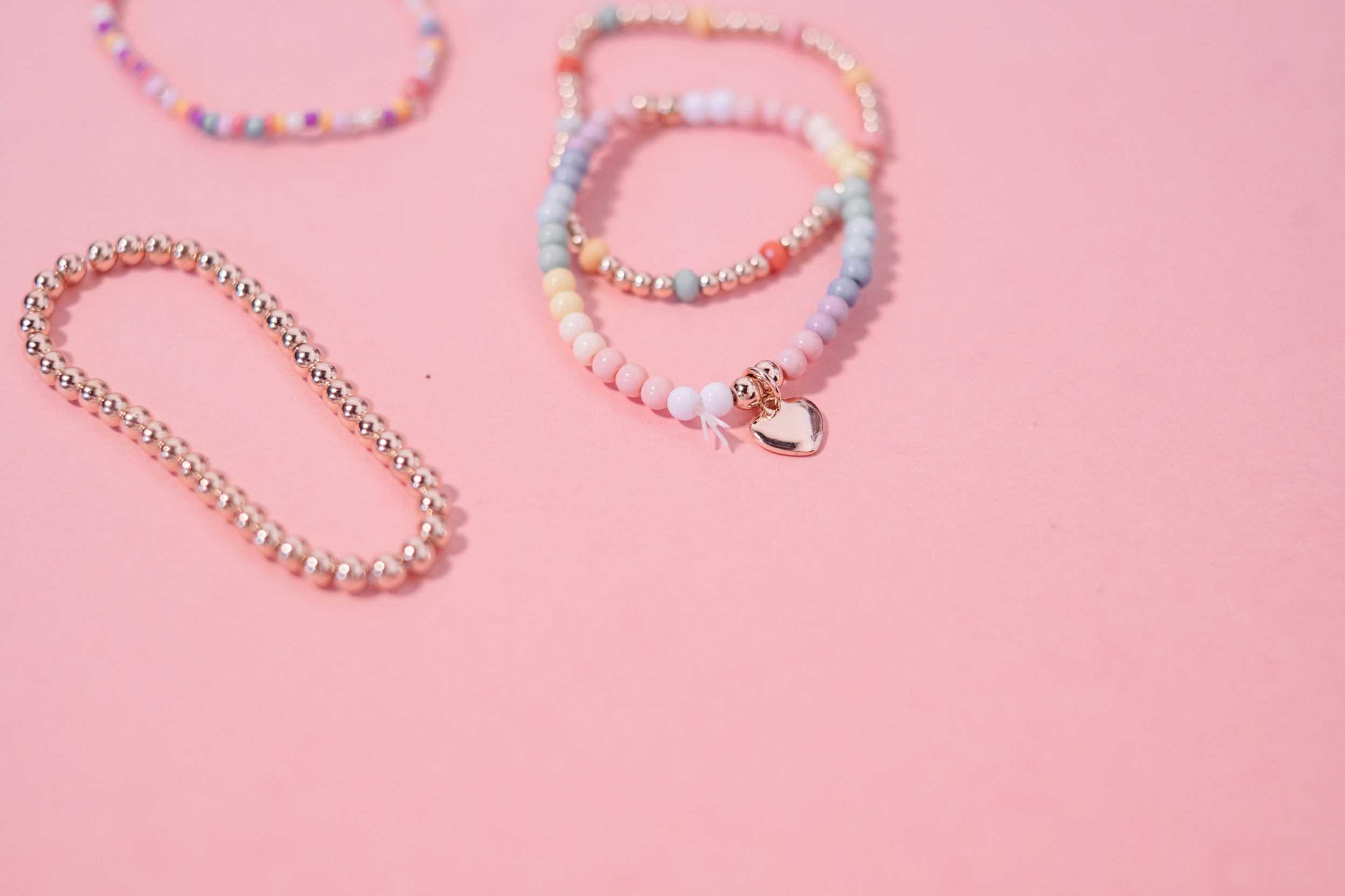 Beaded Bracelets on Pink Background