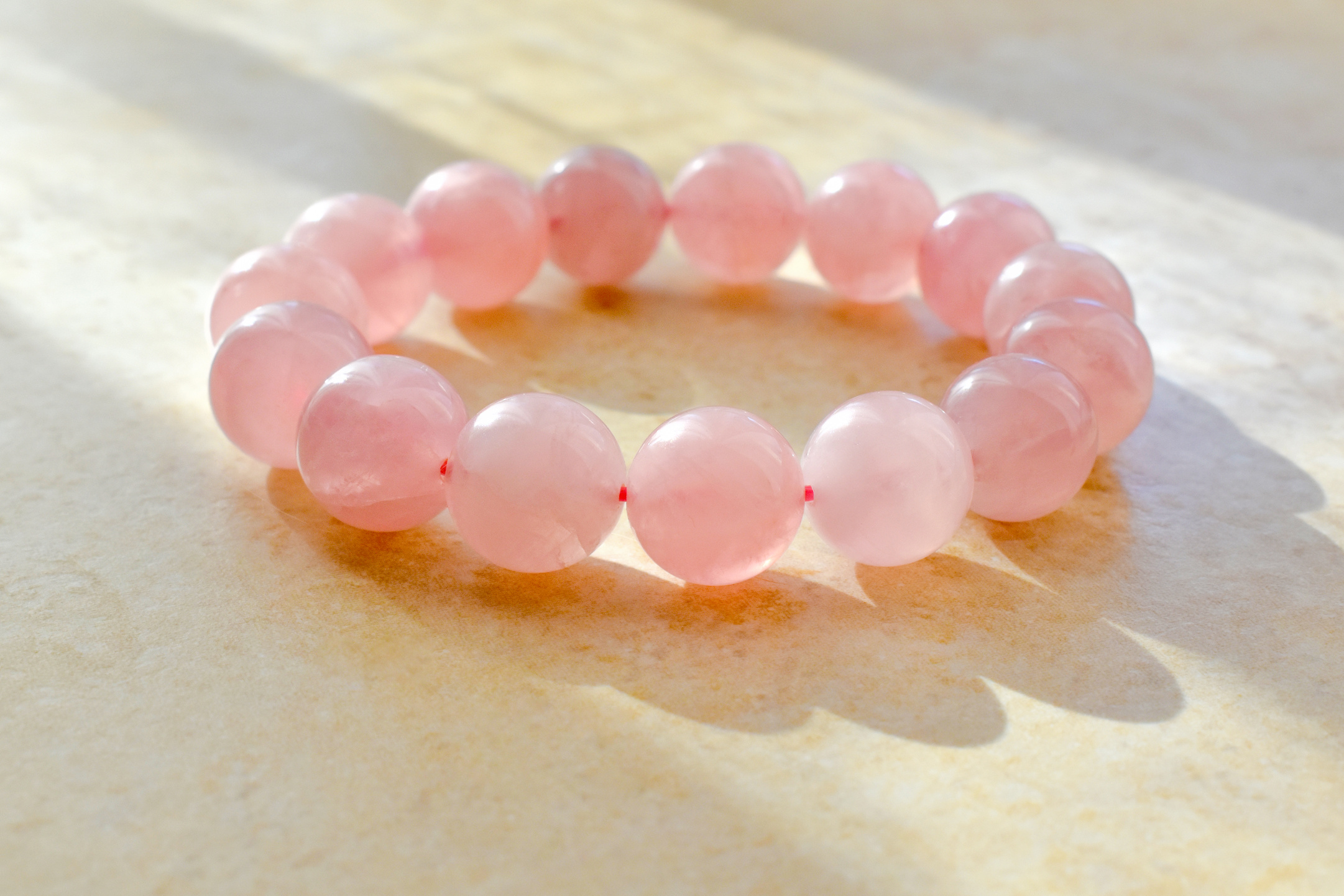 Rose quartz bracelet on the table.